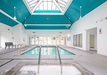 A large indoor swimming pool with a glass ceiling.